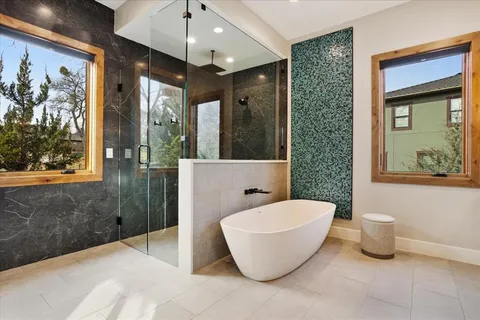 a spacious bathroom with a bathtub and shower