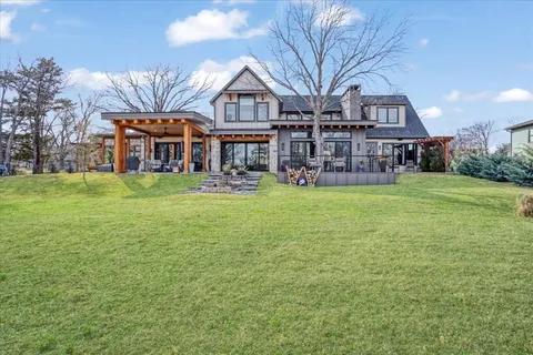a view of a house with a yard and sitting area