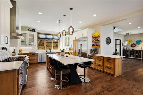 a large kitchen with a table and chairs