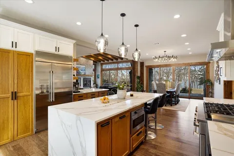 a open kitchen with stainless steel appliances granite countertop a stove and refrigerator