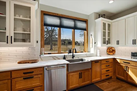 a kitchen with granite countertop a sink and a window