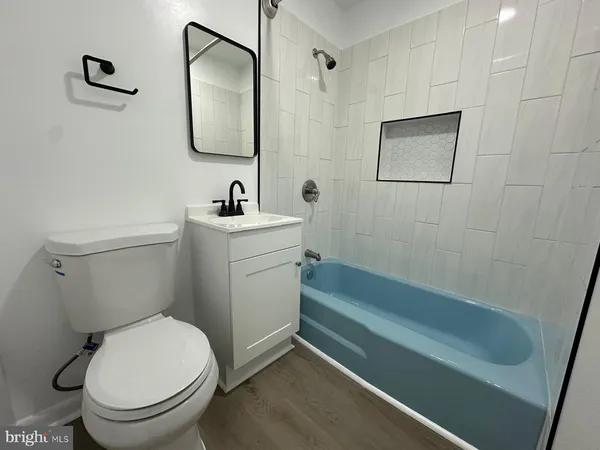 a bathroom with a toilet sink and mirror
