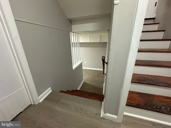 a view of entryway with wooden floor and stairs