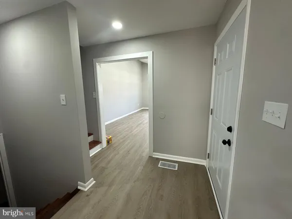 an empty room with wooden floor and closet