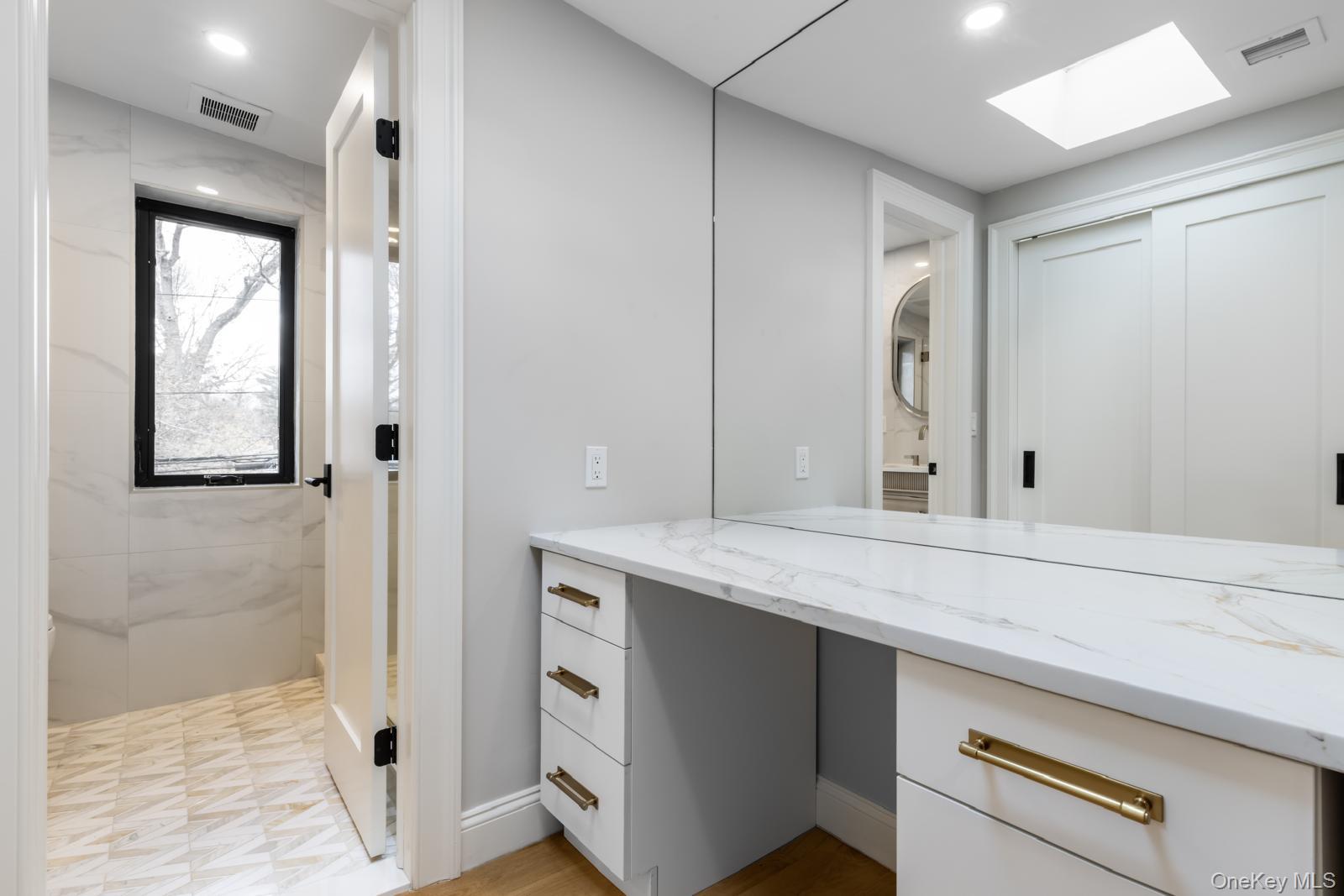 120 Baker Hill Road Great Neck, NY 11023 - Photo 11 of 25 a bathroom with a granite countertop sink and a mirror