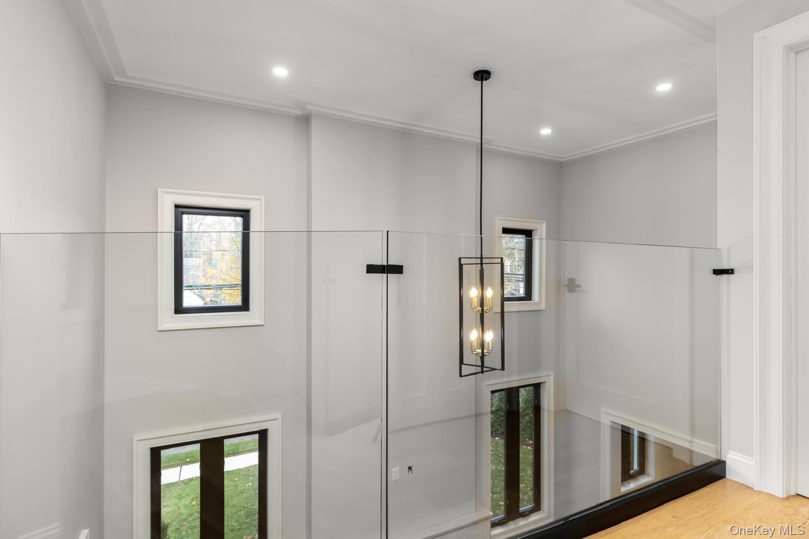 120 Baker Hill Road Great Neck, NY 11023 - Photo 19 of 25 a view of a hallway with wooden floor and staircase