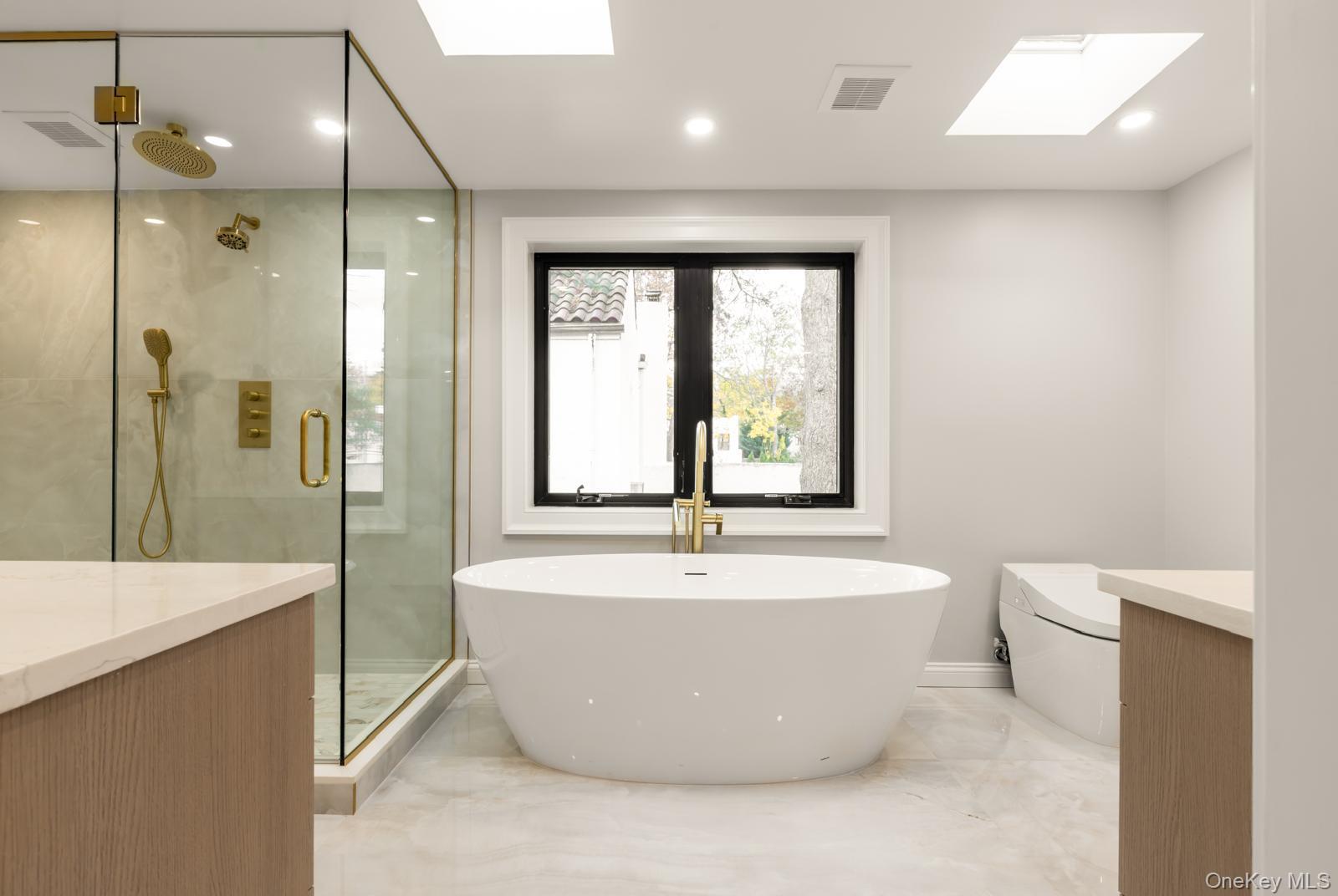 120 Baker Hill Road Great Neck, NY 11023 - Photo 22 of 25 a view of a bathtub in a bathroom