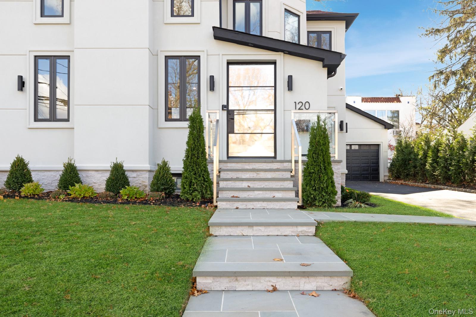 120 Baker Hill Road Great Neck, NY 11023 - Photo 4 of 25 a front view of a house with garden