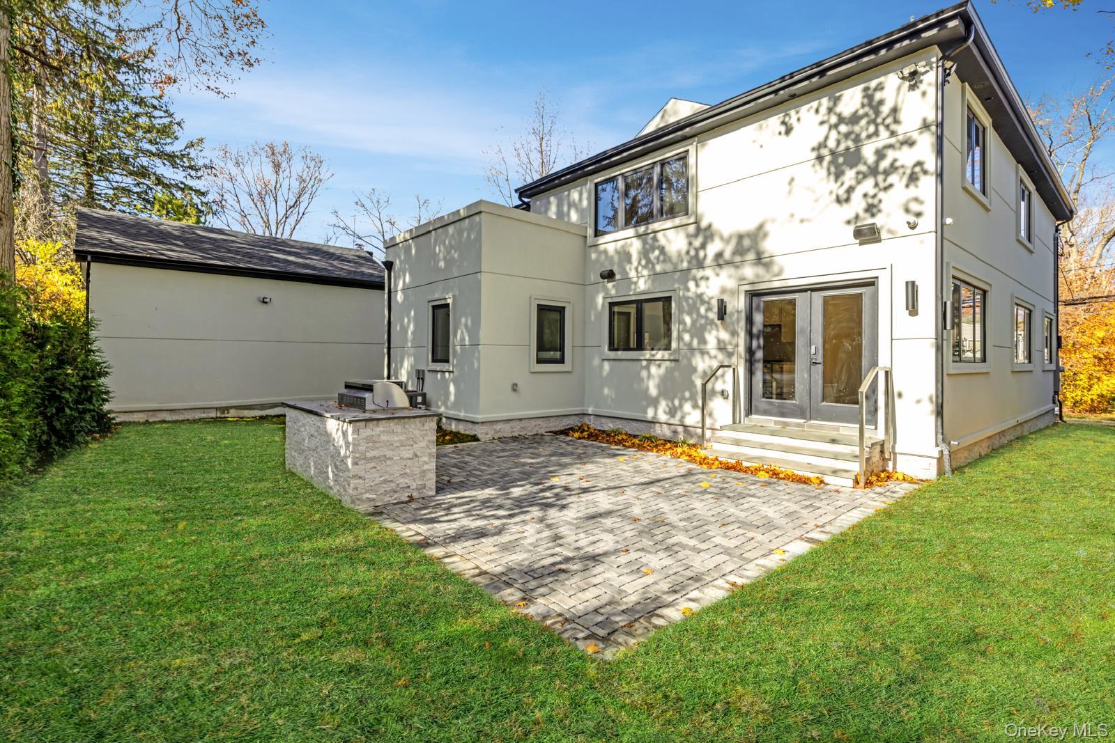 120 Baker Hill Road Great Neck, NY 11023 - Photo 6 of 25 a view of a house with backyard and porch