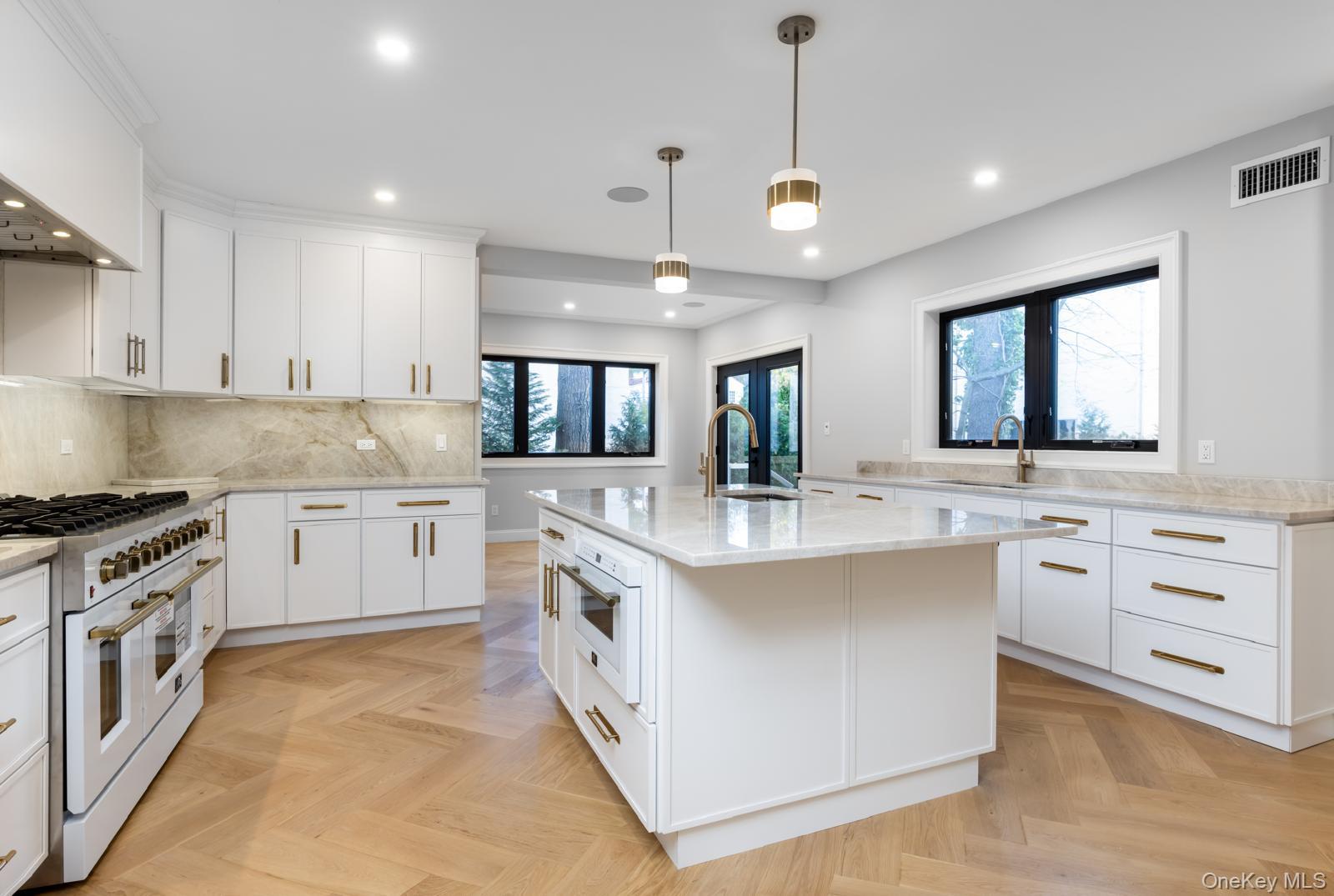 120 Baker Hill Road Great Neck, NY 11023 - Photo 7 of 25 a large kitchen with cabinets and a stove