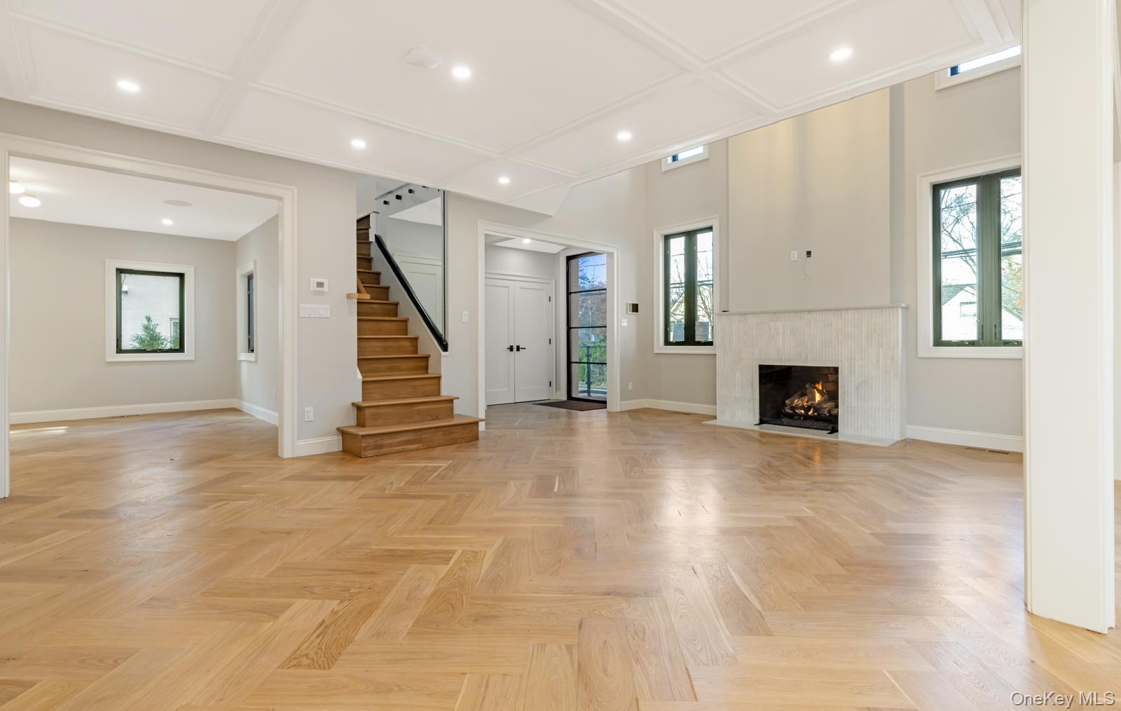120 Baker Hill Road Great Neck, NY 11023 - Photo 9 of 25 an empty room with wooden floor and a fireplace