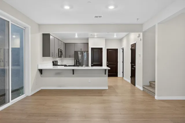 a view of kitchen with kitchen island a refrigerator and a sink