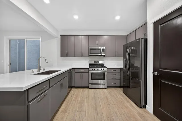 a kitchen with a sink stove and refrigerator