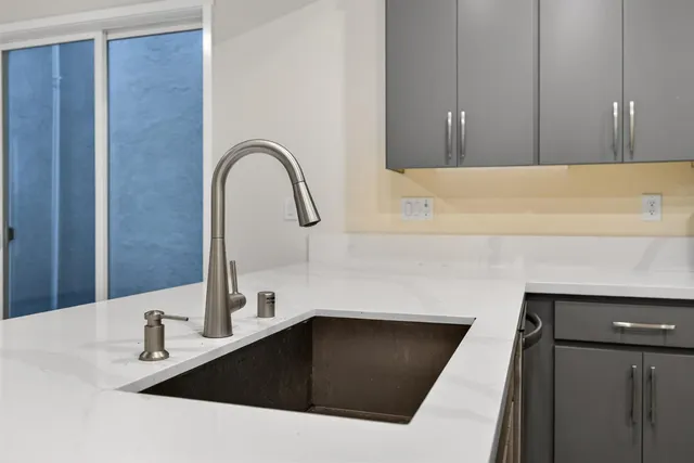 a close view of a sink and a cabinet in a bathroom