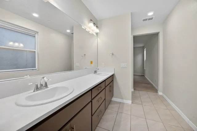a bathroom with a double vanity sink a and a mirror