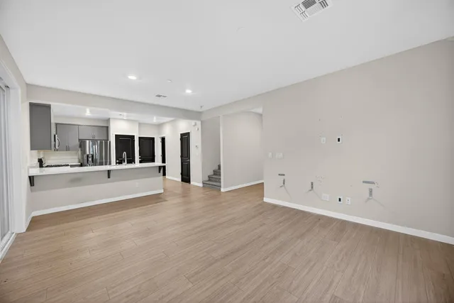 a view of large kitchen with wooden floor