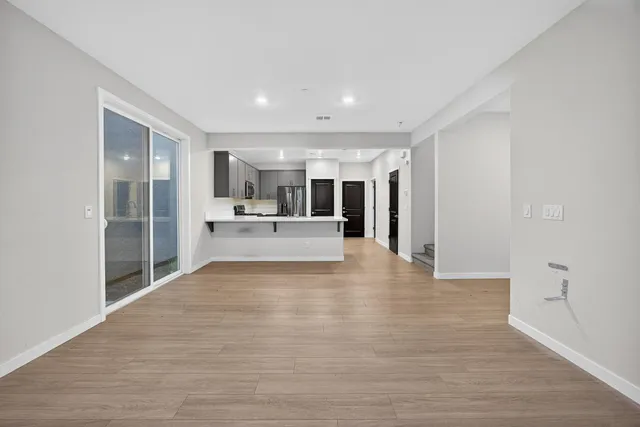 a view of a kitchen with a sink and a refrigerator