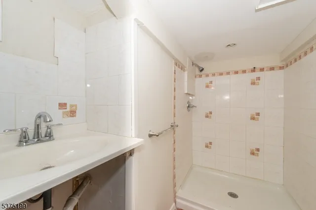 a bathroom with a shower and a sink