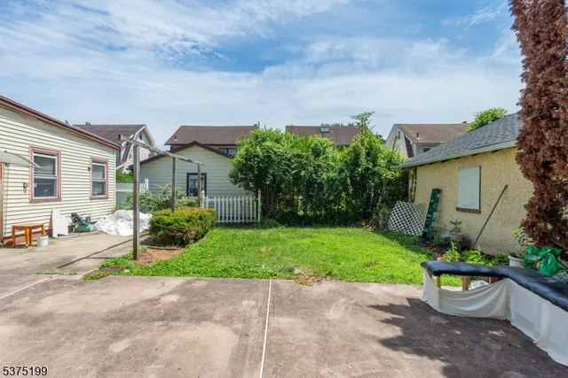 a front view of a house with a yard and a garden