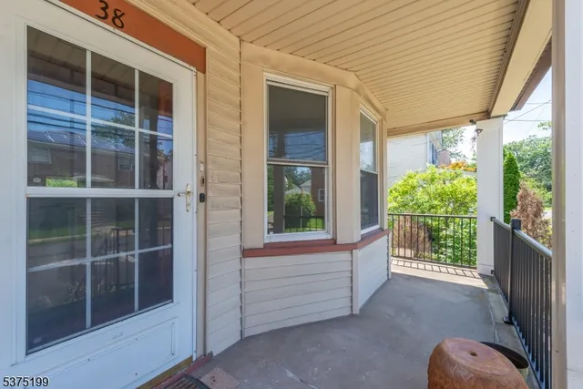 a view of a porch with a floor to ceiling window and wooden fence