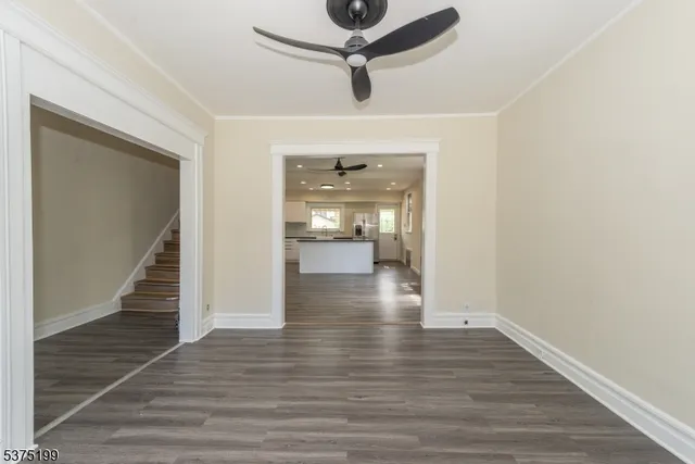 a view of a hallway view with wooden floor and staircase