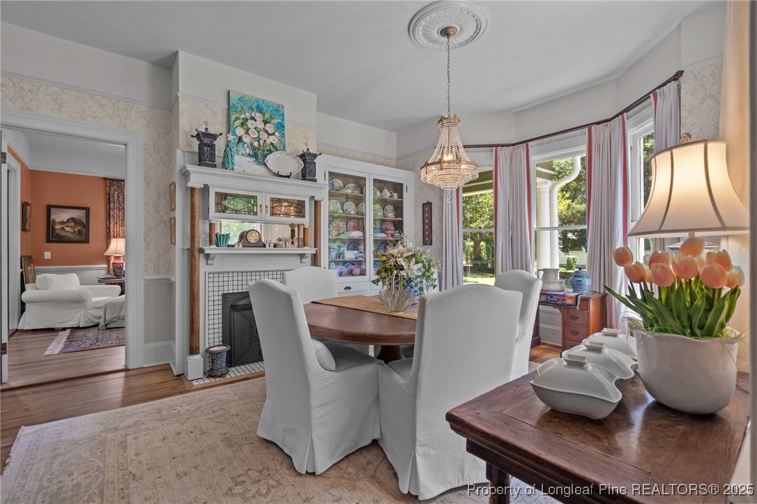300 High Street Aberdeen, NC 28315 - Photo 20 of 50 a dining room with furniture large windows and a chandelier