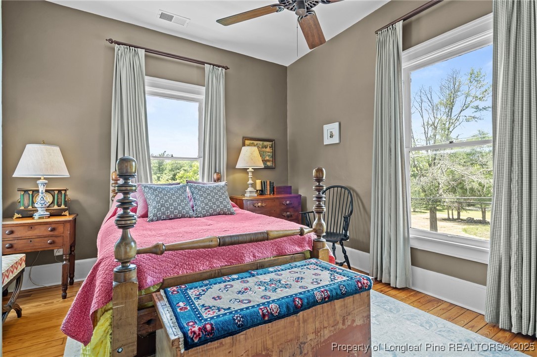 300 High Street Aberdeen, NC 28315 - Photo 37 of 50 a bedroom with a bed windows and a chandelier