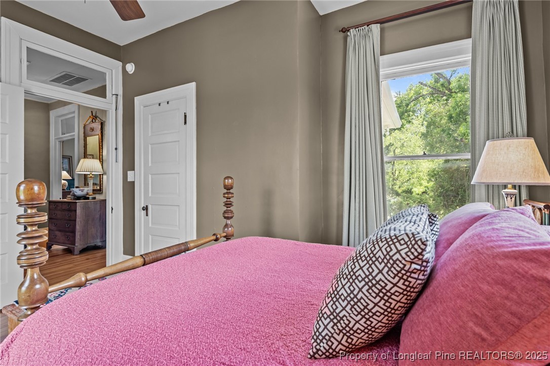 300 High Street Aberdeen, NC 28315 - Photo 38 of 50 a bedroom with a bed and wooden floor