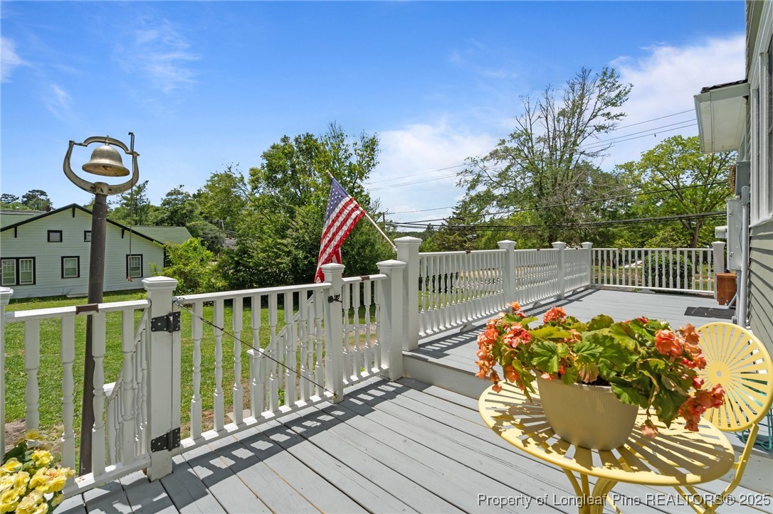 300 High Street Aberdeen, NC 28315 - Photo 46 of 50 a view of balcony with wooden floor and outdoor seating