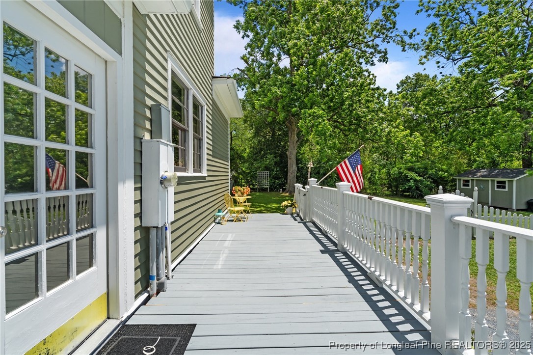300 High Street Aberdeen, NC 28315 - Photo 50 of 50 a balcony with view of trees and buildings in the background