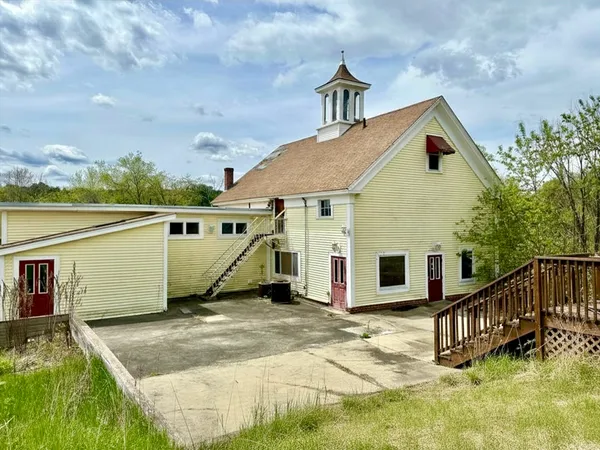 a view of a house with wooden fence