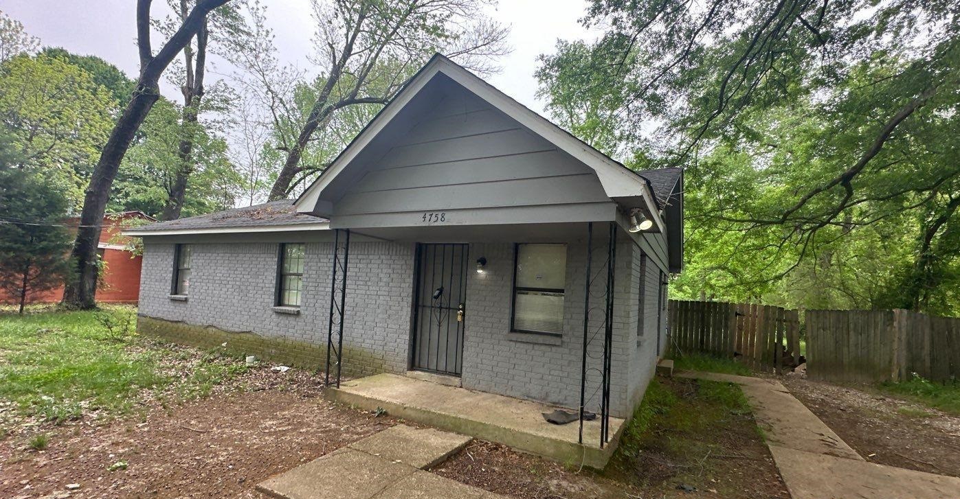 4758 11th Road Memphis, TN 38109 - Photo 1 of 8 a front view of a house with a yard and tree