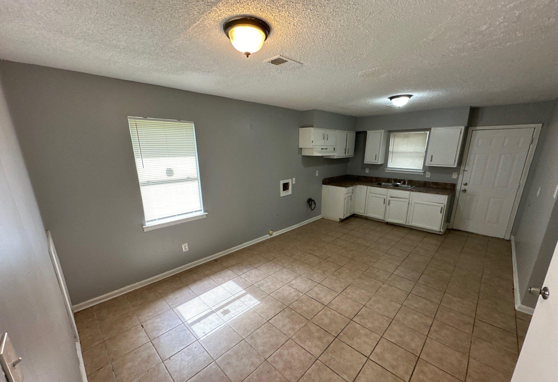 4758 11th Road Memphis, TN 38109 - Photo 2 of 8 a large white kitchen with a stove a sink dishwasher and a refrigerator