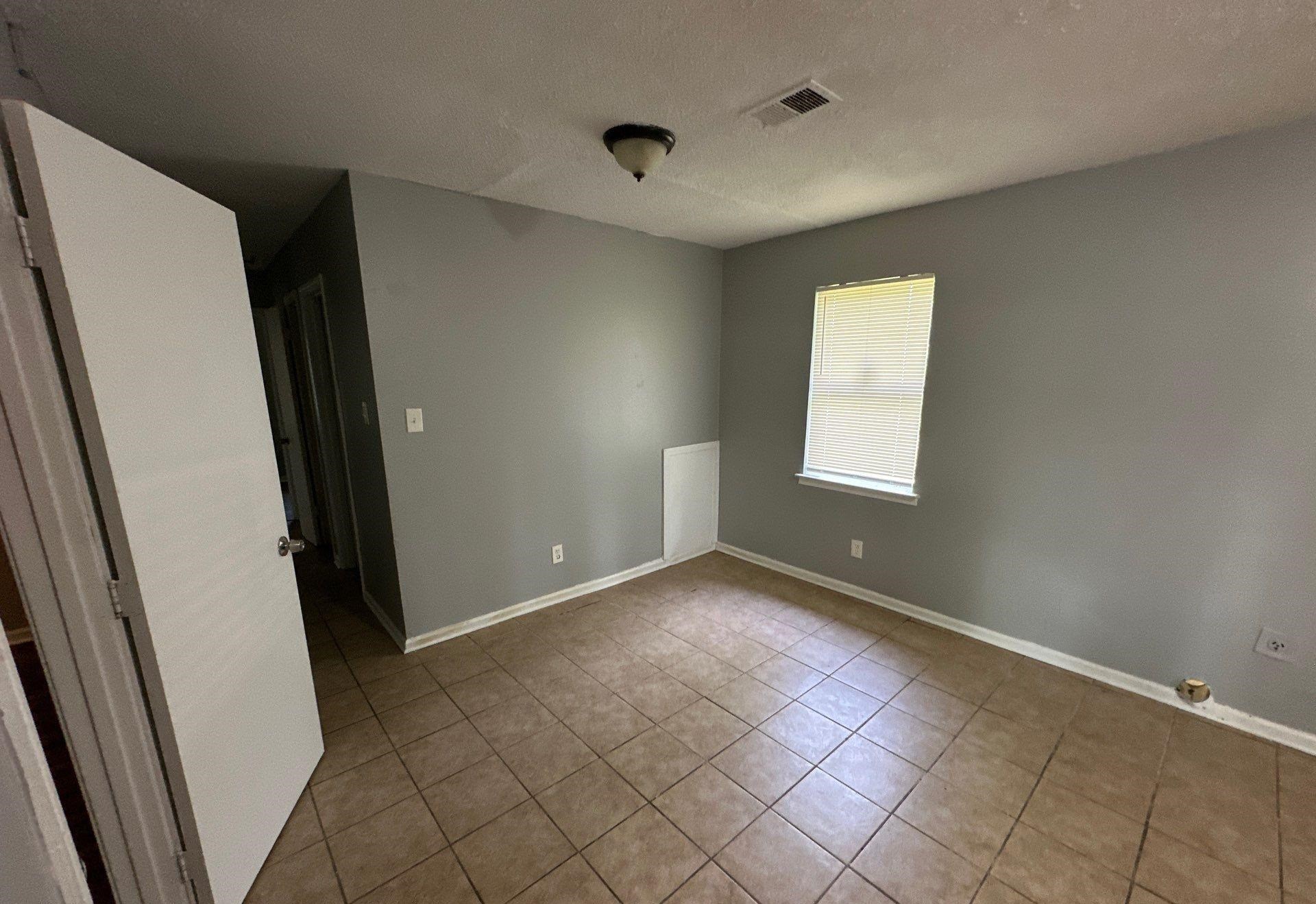 4758 11th Road Memphis, TN 38109 - Photo 3 of 8 an empty room with windows