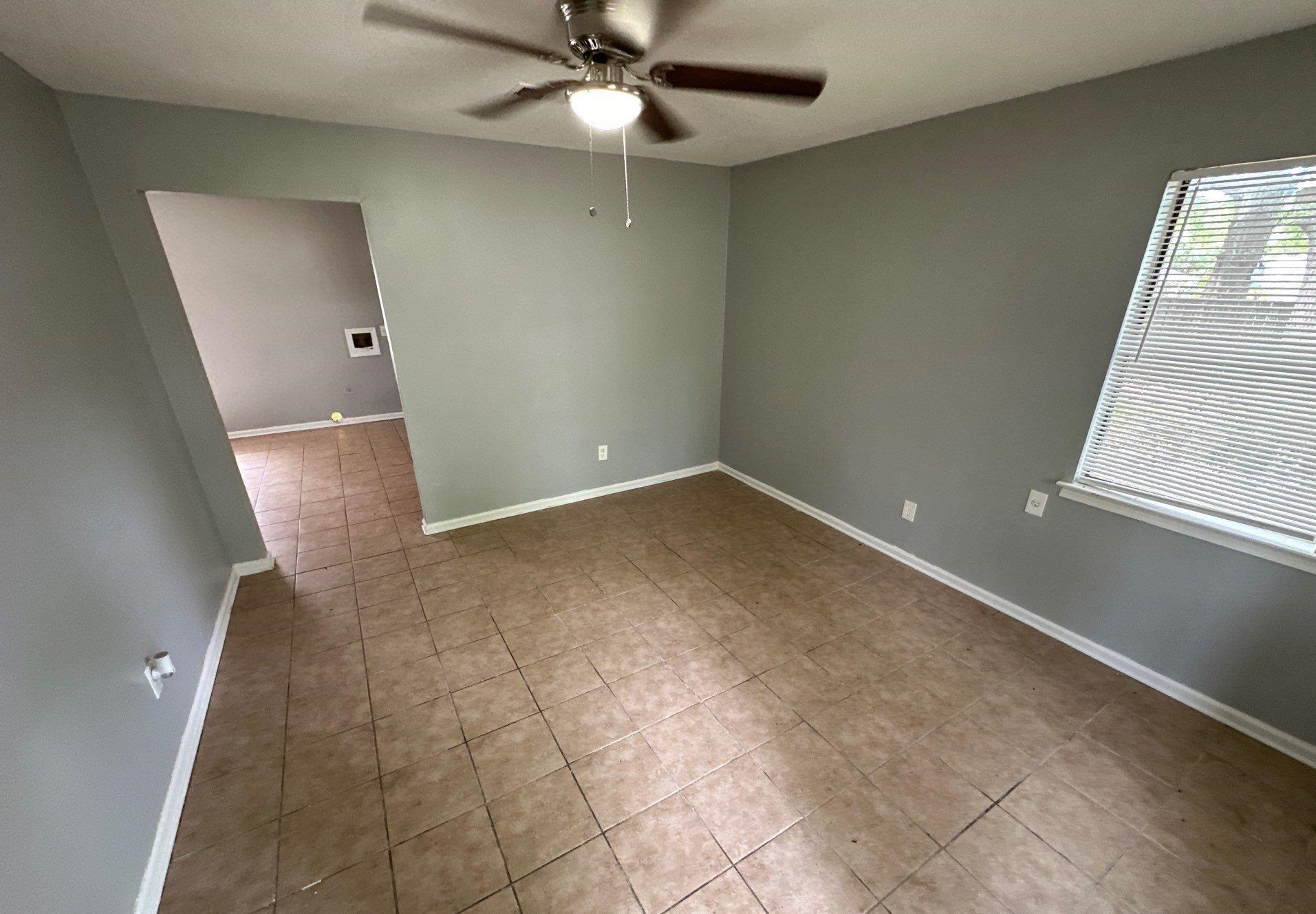 4758 11th Road Memphis, TN 38109 - Photo 4 of 8 wooden floor in an empty room with a window