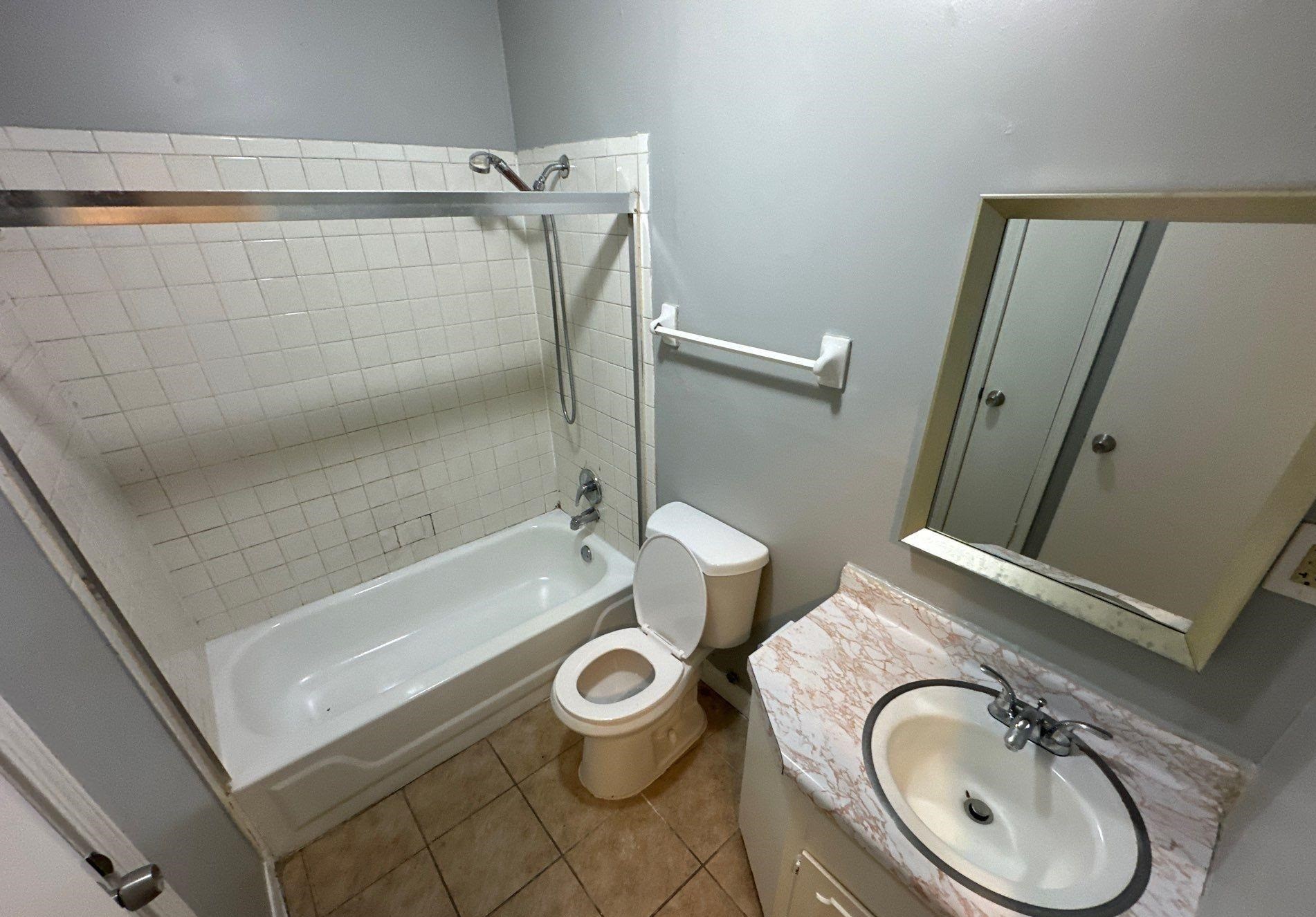 4758 11th Road Memphis, TN 38109 - Photo 8 of 8 a bathroom with a sink a toilet and shower