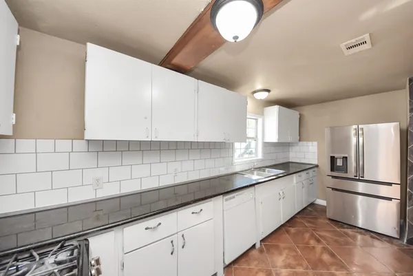 a kitchen with a sink stainless steel appliances and cabinets