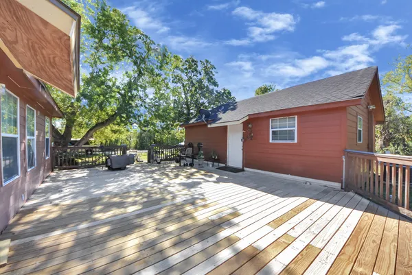 a view of backyard with a table and chairs and wooden fence