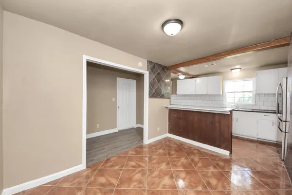 a view of a kitchen with a sink and cabinets
