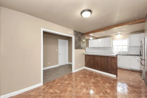 a view of a kitchen with a sink and cabinets