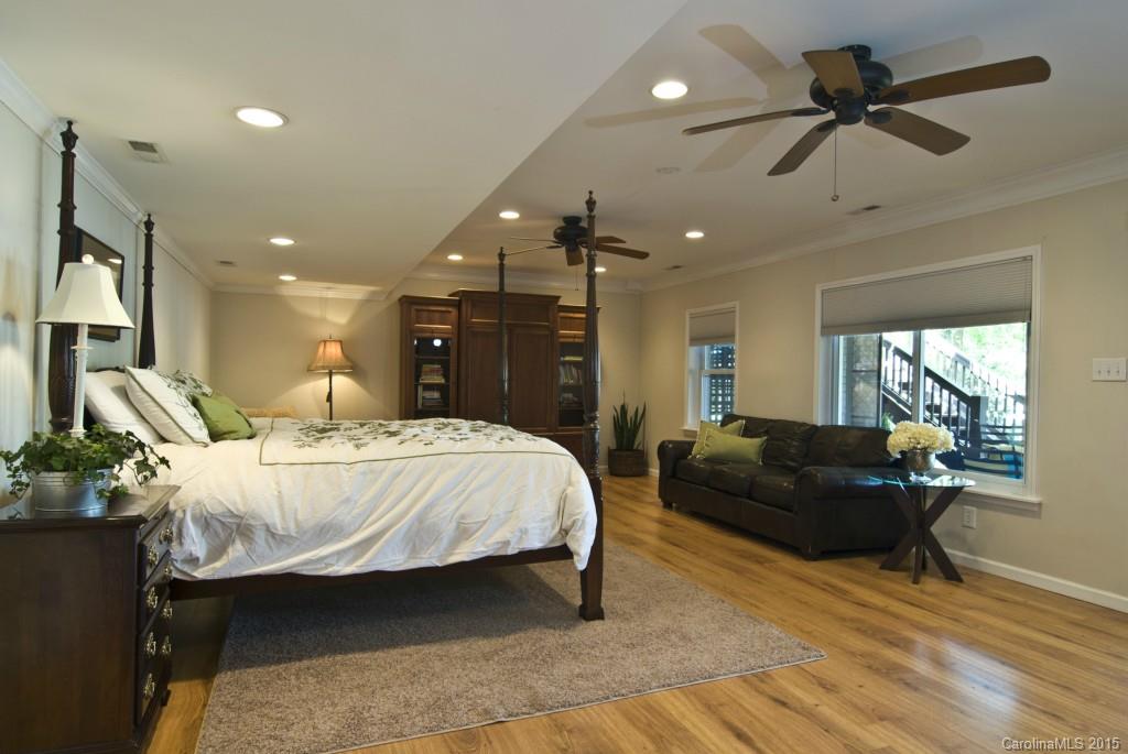 3320 Lake Shore Road South Denver, NC 28037 - Photo 15 of 21 a spacious bedroom with a bed a couch and a chandelier