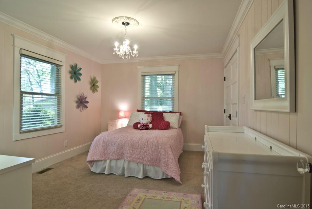 3320 Lake Shore Road South Denver, NC 28037 - Photo 10 of 21 a bedroom with a bed and a chandelier