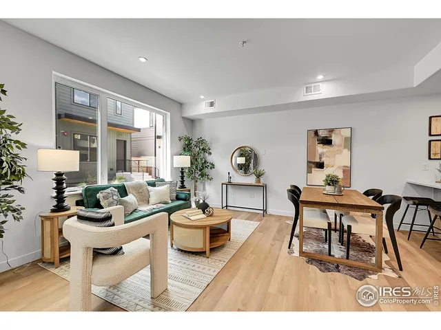 a living room with furniture a rug and a large window