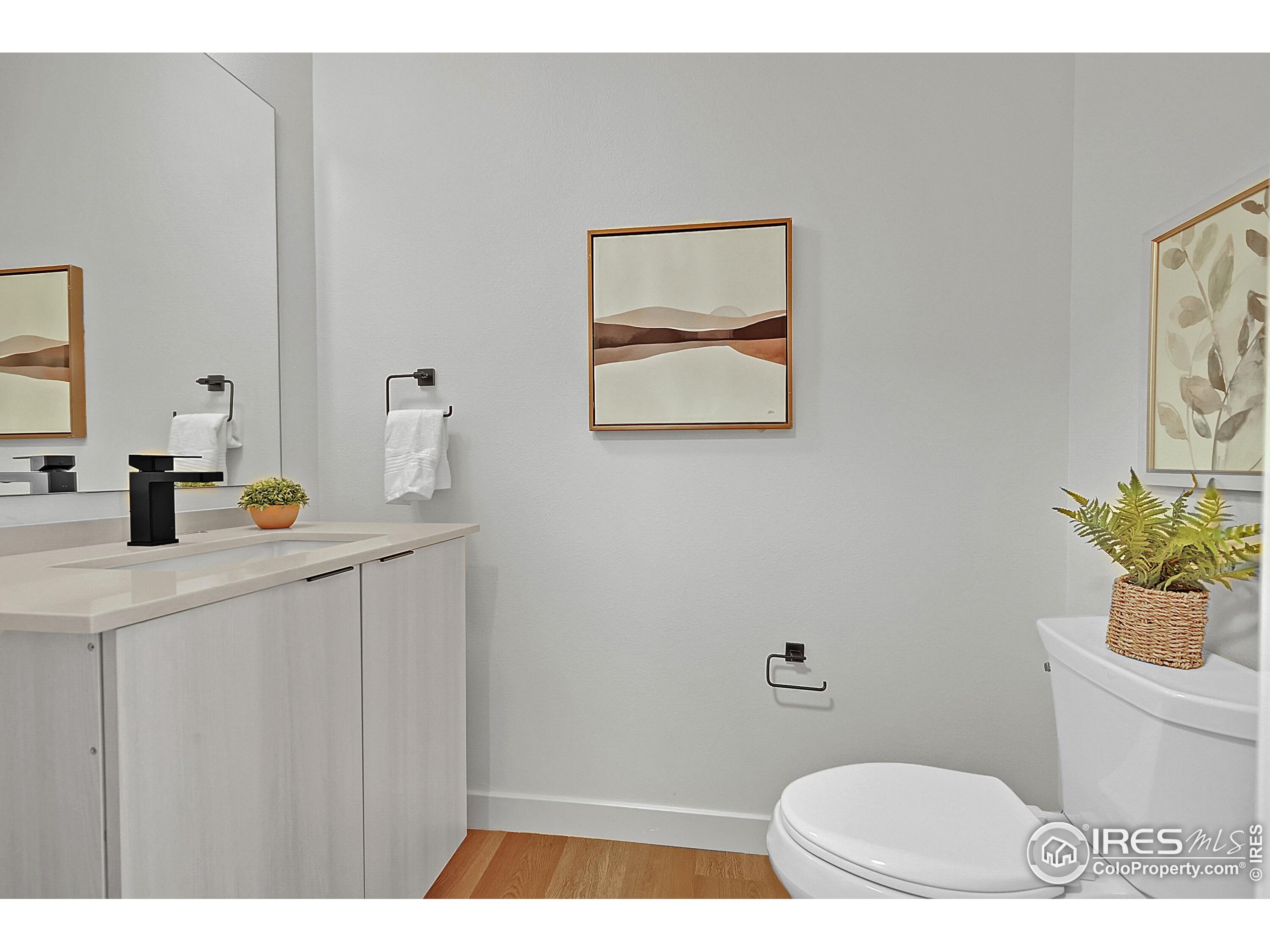 777 East County Line Road Erie, CO 80516 - Photo 6 of 15 a bathroom with a toilet a sink and mirror