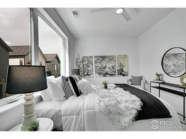 a bedroom with a large bed and a window