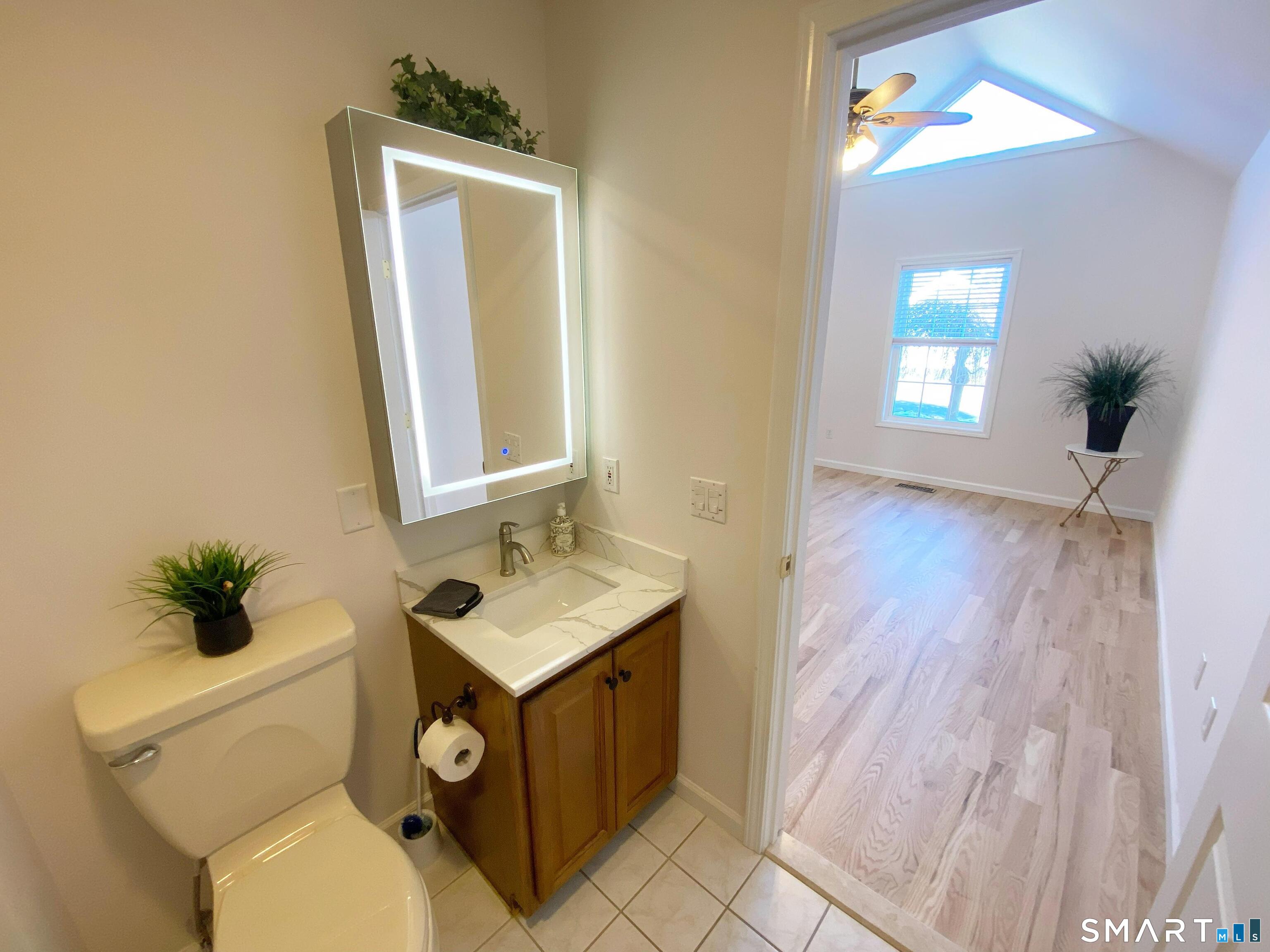 8 St George Place, Unit 8 Newtown, CT 06482 - Photo 10 of 31 a bathroom with a toilet sink and mirror