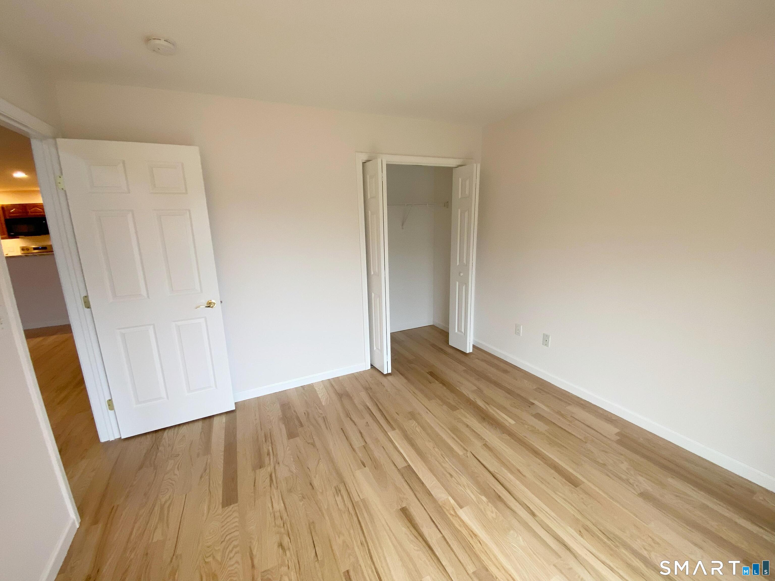 8 St George Place, Unit 8 Newtown, CT 06482 - Photo 16 of 31 a view of empty room with wooden floor