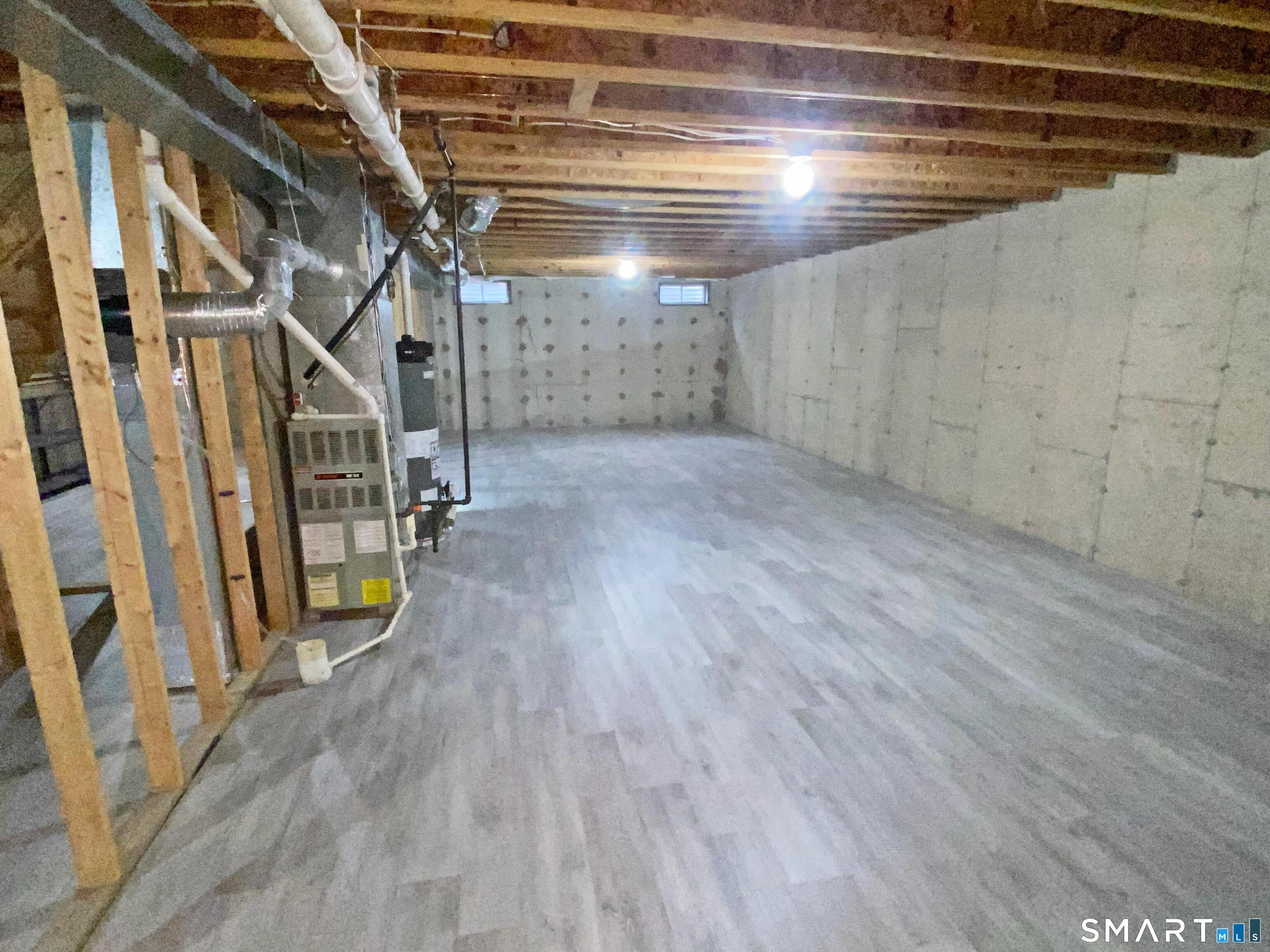 8 St George Place, Unit 8 Newtown, CT 06482 - Photo 19 of 31 Full basement with new laminate flooring