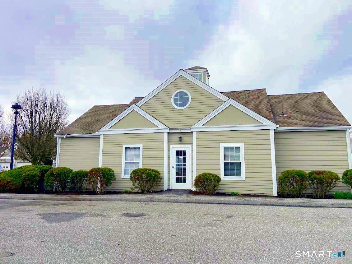 8 St George Place, Unit 8 Newtown, CT 06482 - Photo 25 of 31 a front view of a house with a yard and garage