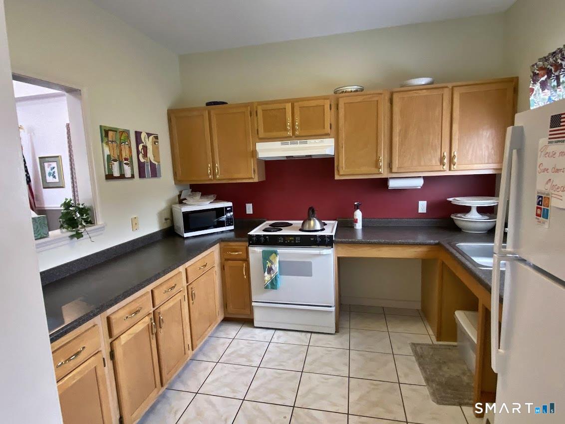 8 St George Place, Unit 8 Newtown, CT 06482 - Photo 27 of 31 a kitchen with stainless steel appliances a sink cabinets and wooden floor